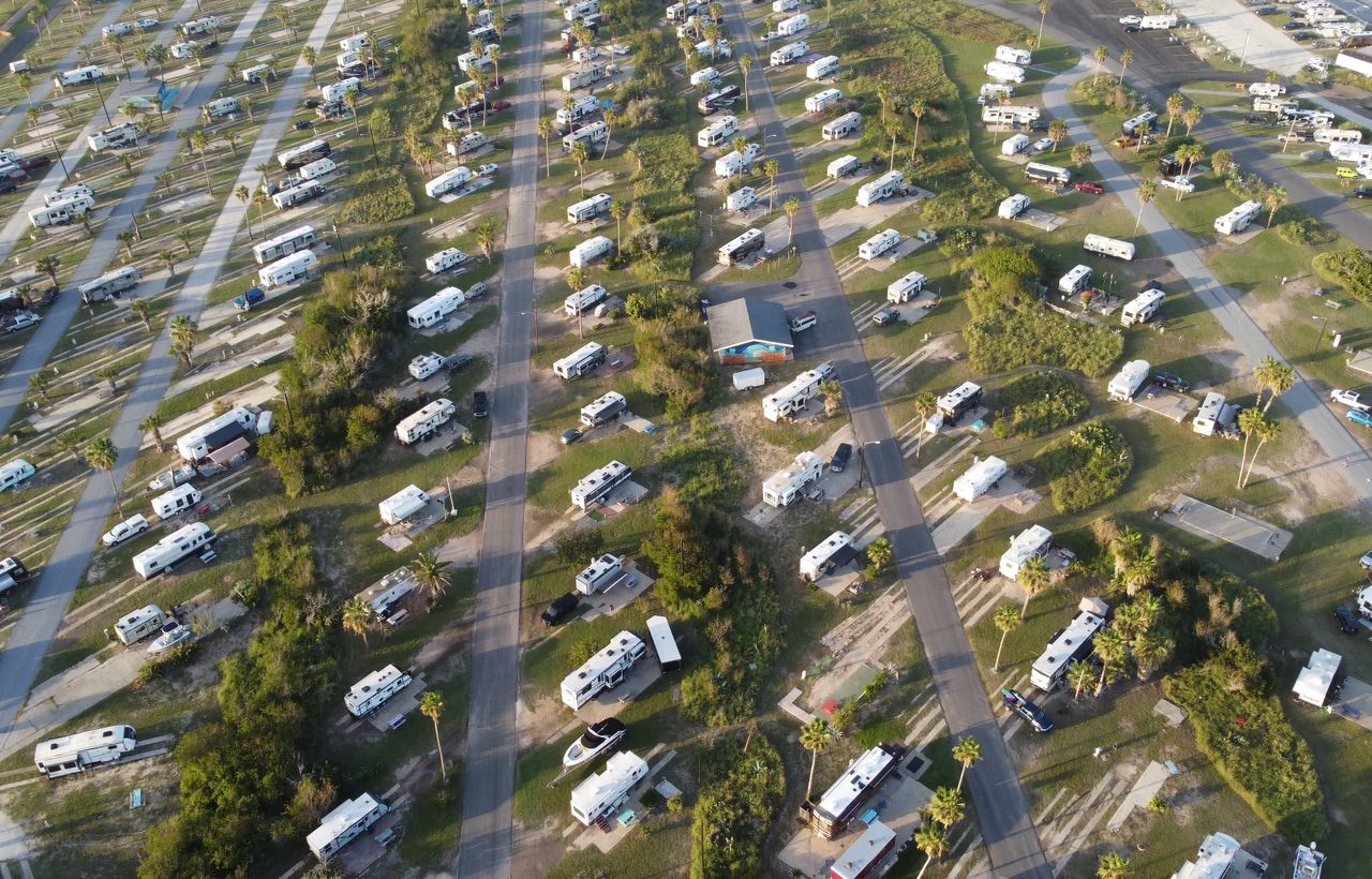 Aerial view of a campground full of RVs at sunset