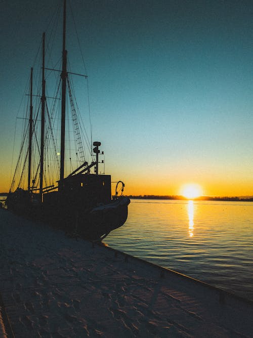 Silhouette of Ship in Port on Sunset