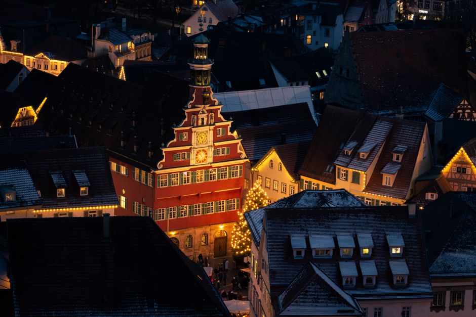 Esslingen Old Town Hall illuminated at night with festive winter decorations.