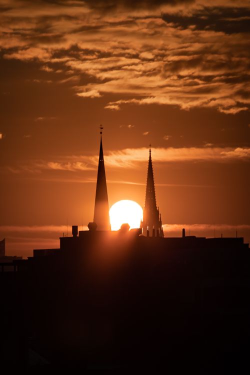 Free Captivating silhouette of Hamburg's skyline with church towers at sunset. Stock Photo
