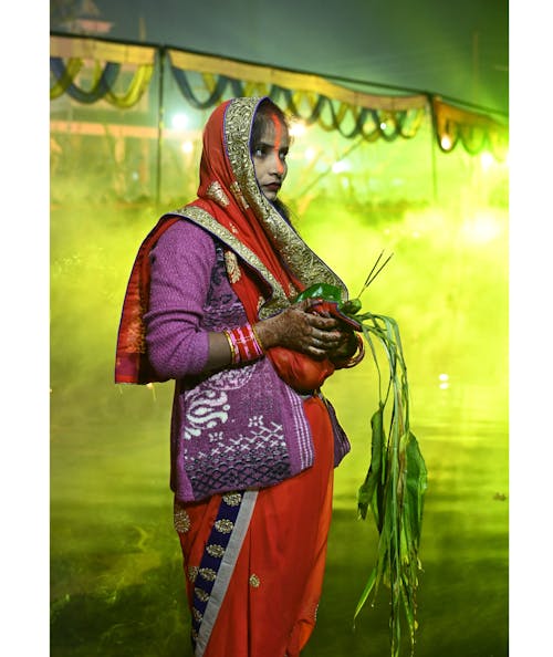 Indian Woman in Traditional Clothing Standing and Holding Groceries in her Hand 