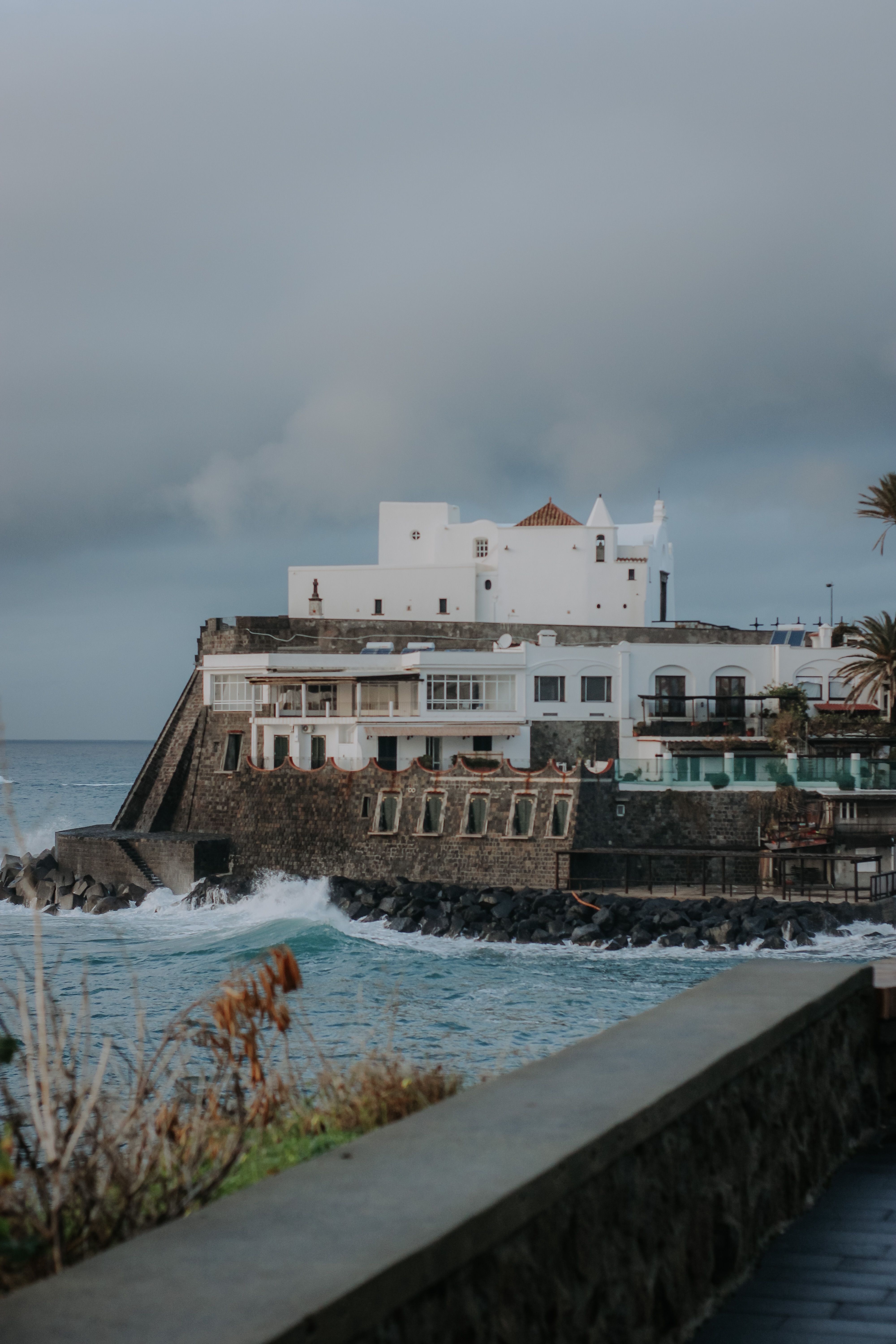 Captivating coastal architecture in Italy with a dramatic seascape backdrop.