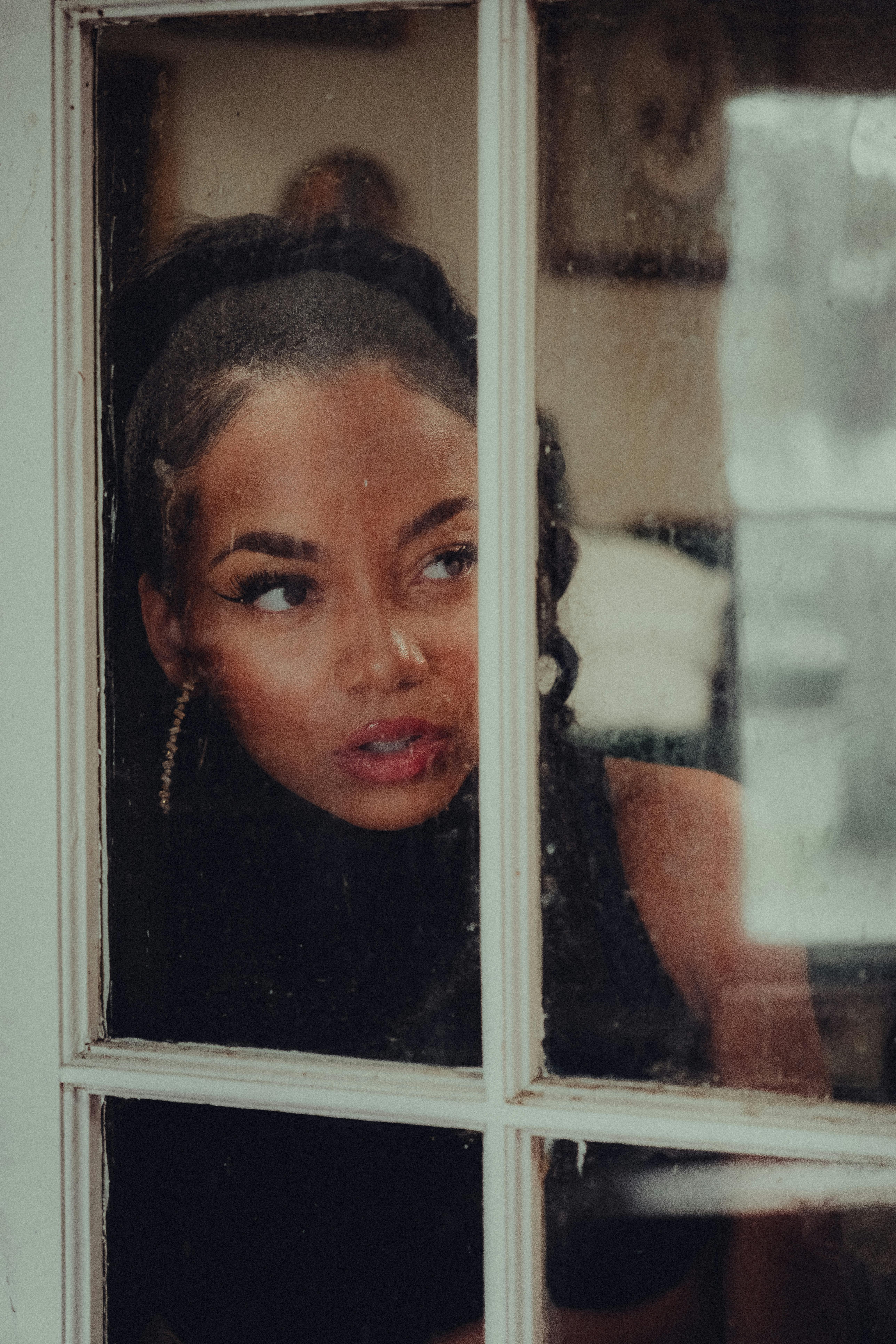 a woman looking out of a window