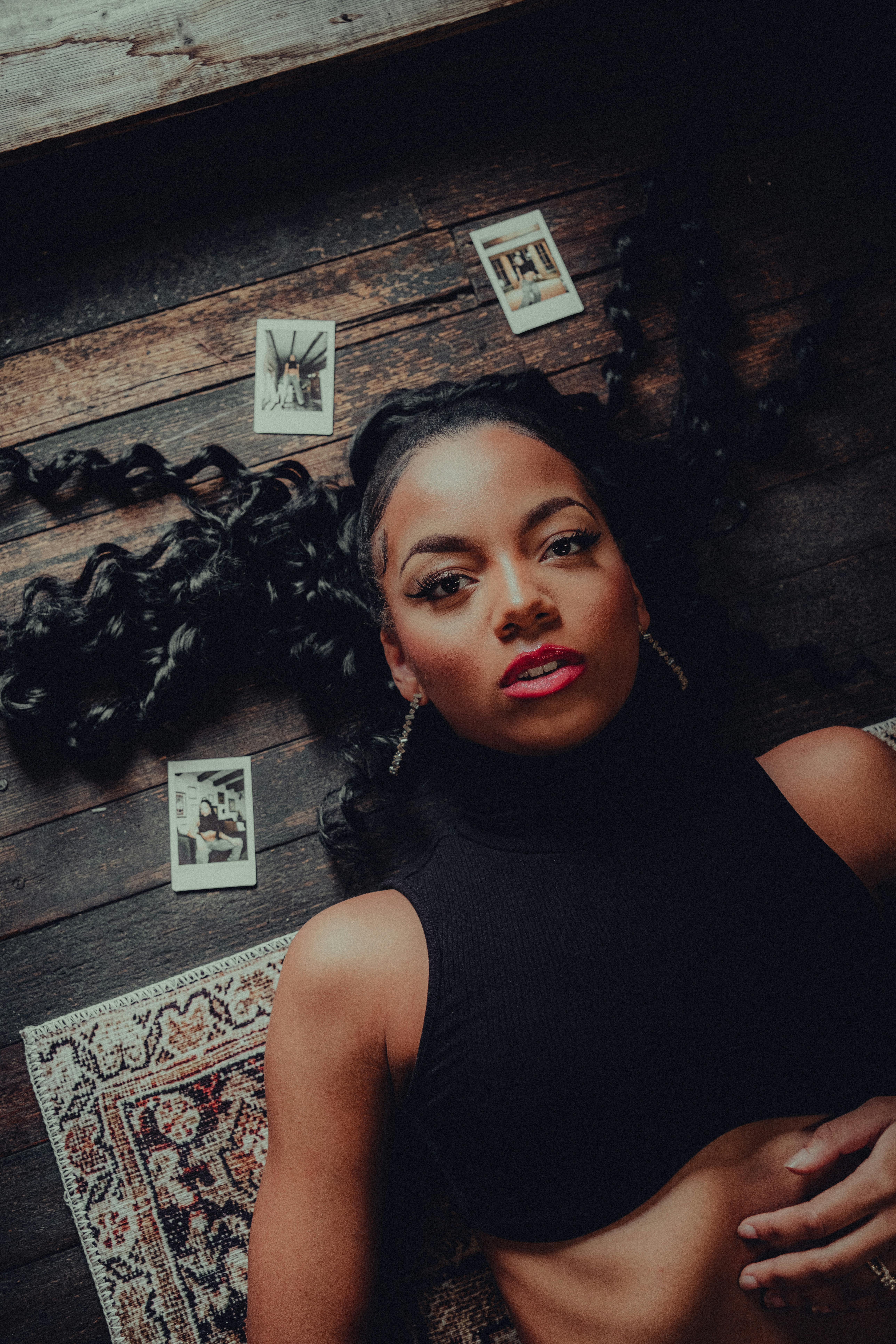 a woman laying on a rug with cards in her hand