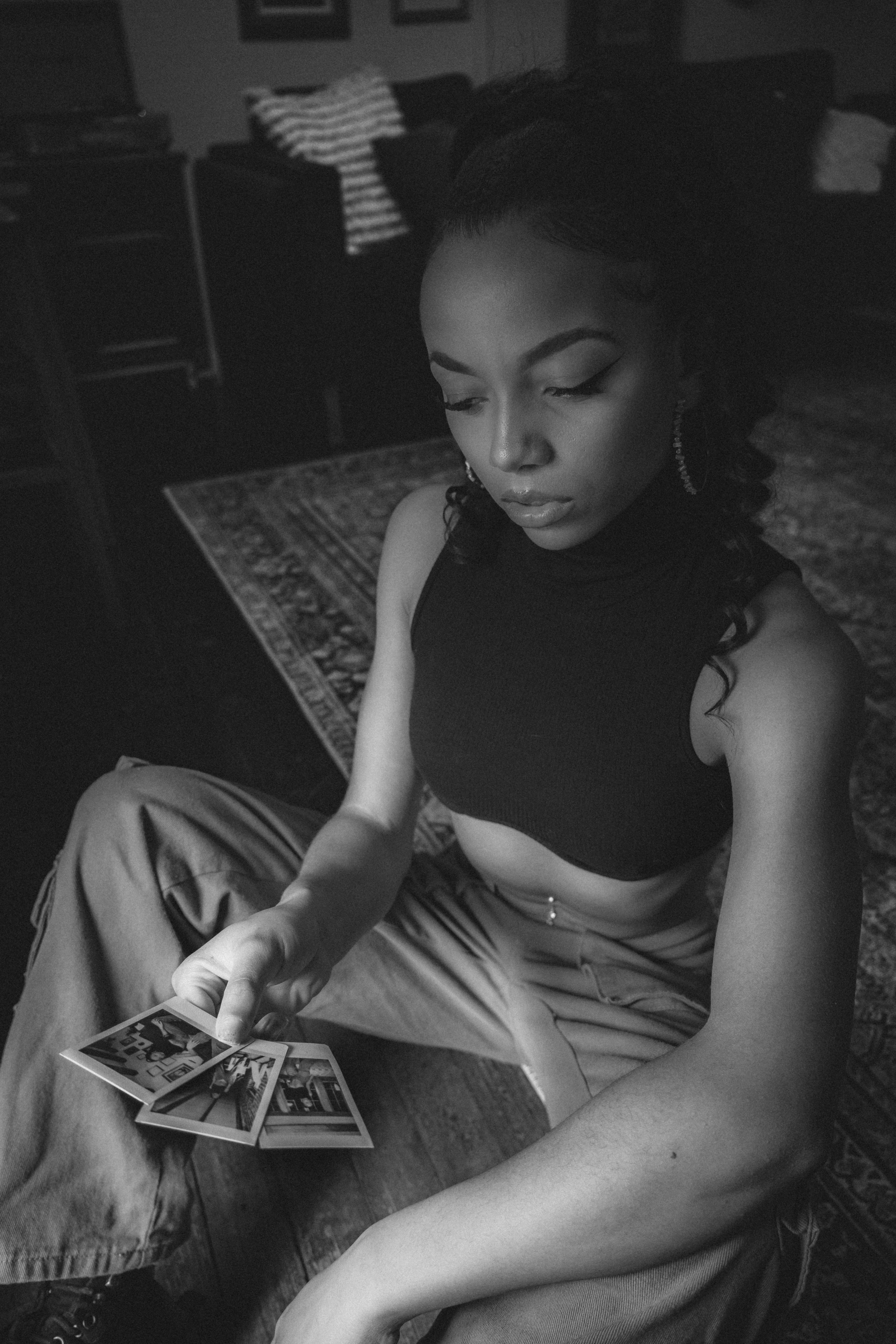 a woman sitting on the floor playing cards