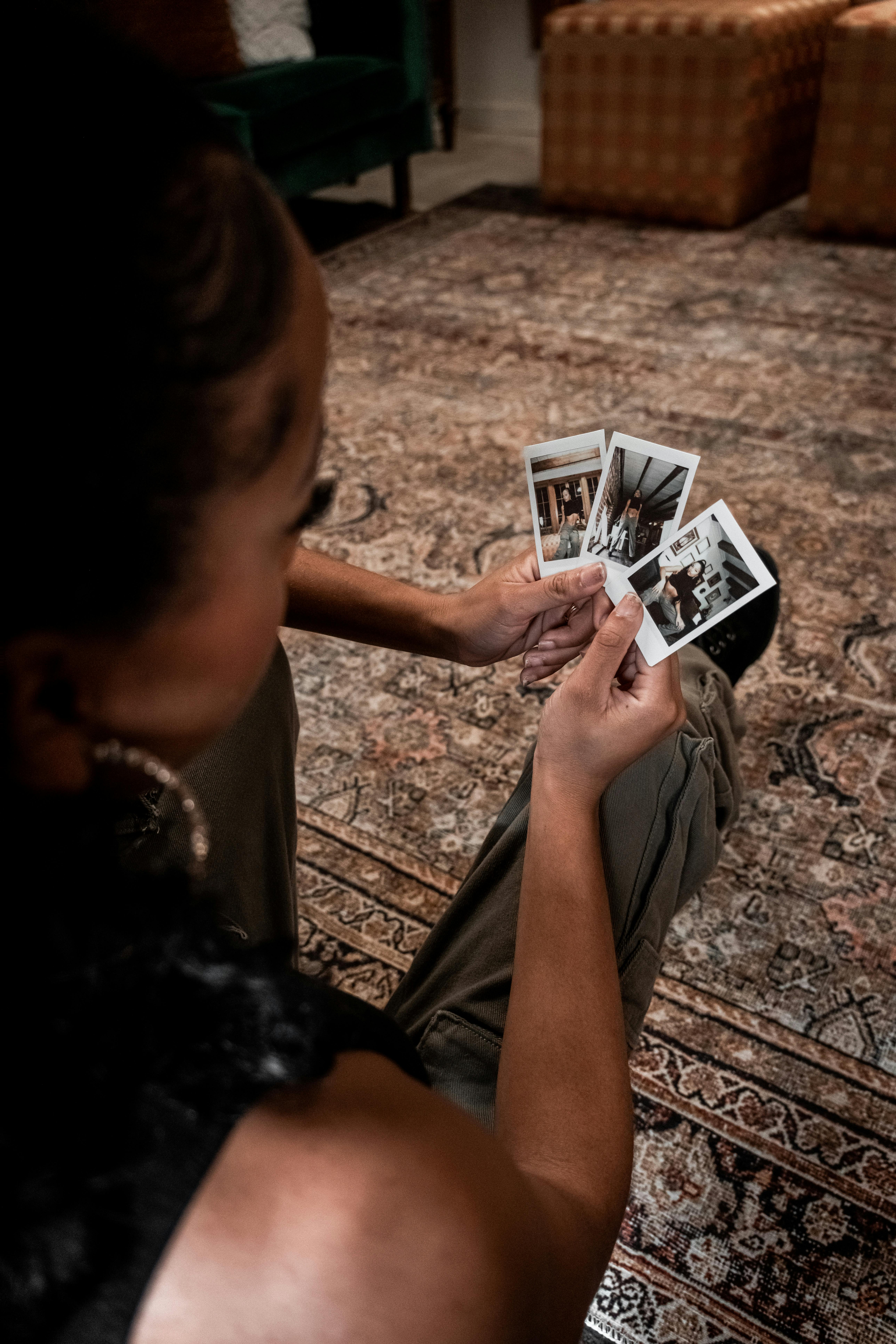 a woman is sitting on the floor holding cards