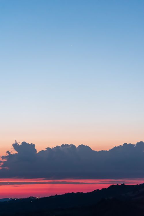 Free Beautiful twilight with vibrant sunset colors over landscape and clouds. Stock Photo