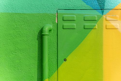 Free Vibrant geometric mural on an urban wall with bright colors and textures. Stock Photo