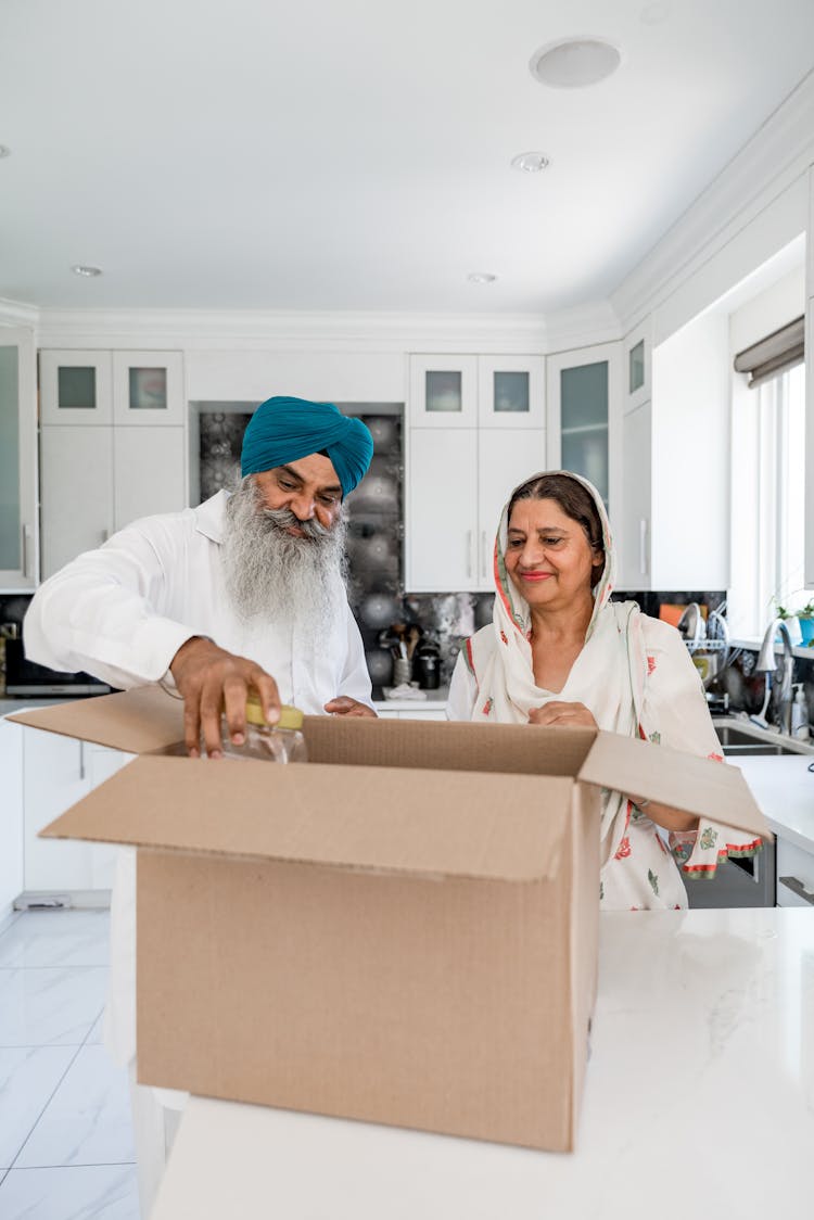 Woman And Man With Box In Room