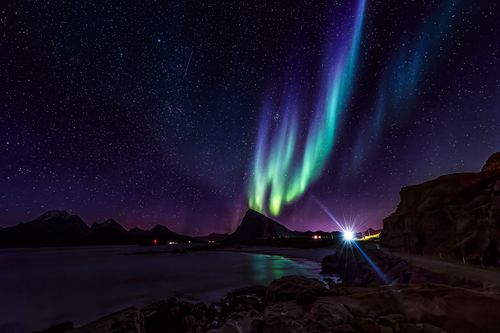 Free Capture the ethereal beauty of the Northern Lights illuminating the Lofoten Islands' landscape at night. Stock Photo