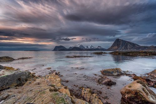 Free Serene ocean view with dramatic sky and mountains in Napp, Nordland, Norway. Stock Photo