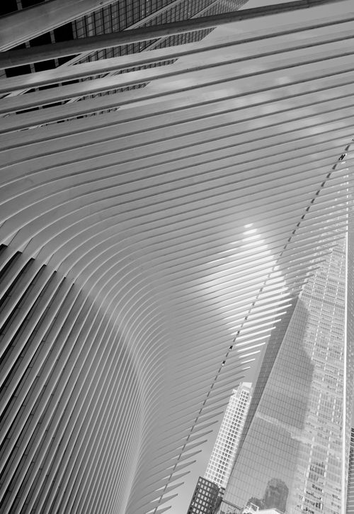 Free Dynamic black and white photo of futuristic architecture against a city skyline. Stock Photo