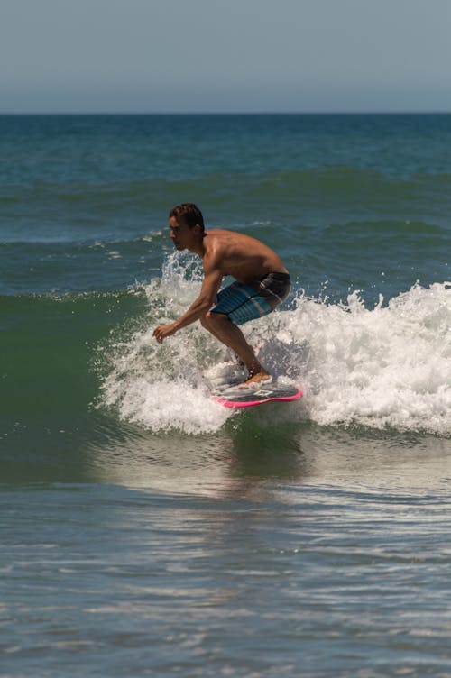 Photo of a Man Surfining
