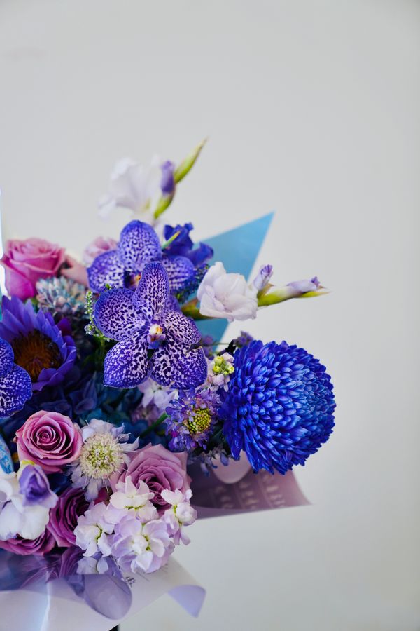 Vibrant purple flower bouquet in a glass vase