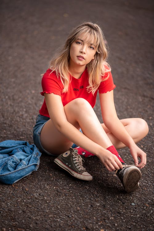 Young Blonde Woman Sitting on the Street