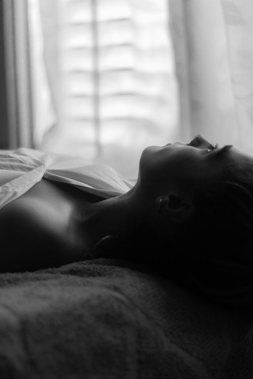 Grayscale Photo of a Woman Lying on the Bed · Free Stock Photo
