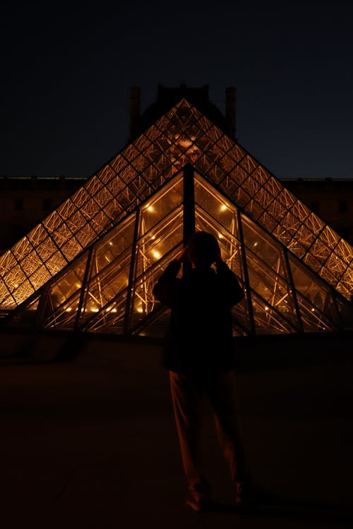A Person Standing Near the Louvre Pyramid