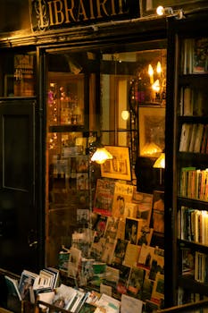 Cozy Parisian bookstore with warm lighting and books on display, perfect for book lovers.