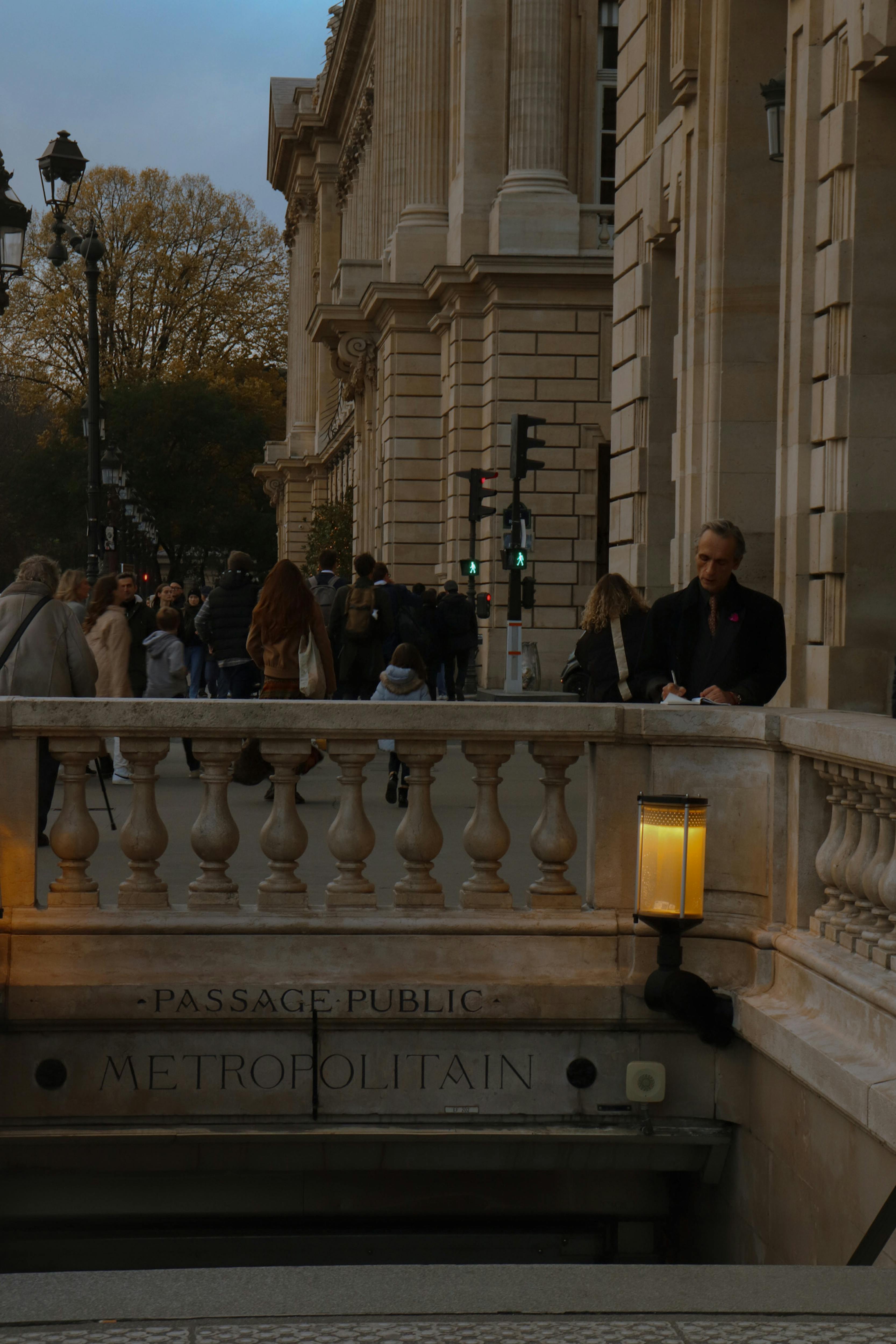 people walking on a sidewalk near a building