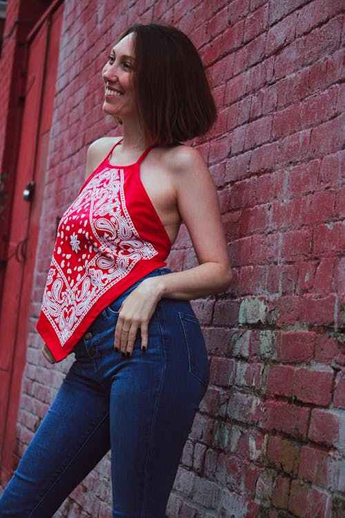 Smiling Woman Standing in front of a Brick Wall