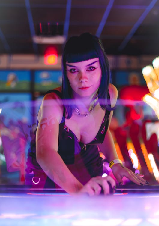 Free A Woman with Bangs Playing Air Hockey Stock Photo