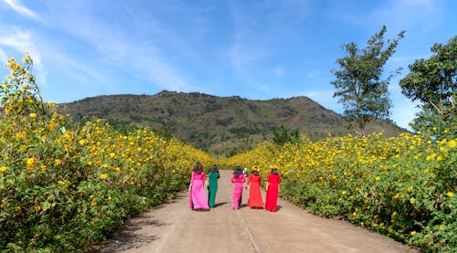 A Group of Women Walking on the Road
