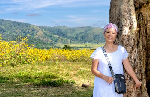 A Woman Standing Beside a Tree