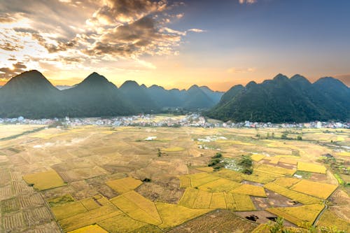 An Aerial Shot of an Agricultural Field with Mountains in the Background