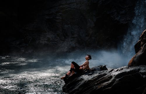 Man Sitting at the Waterfall