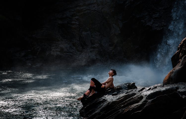 Man Sitting At The Waterfall