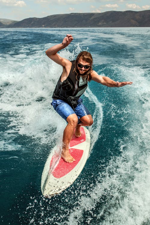 Man Surfing on Board in Ocean