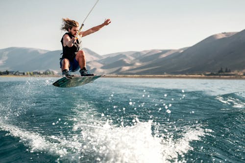 Man Wakeboarding in Mountains Landscape