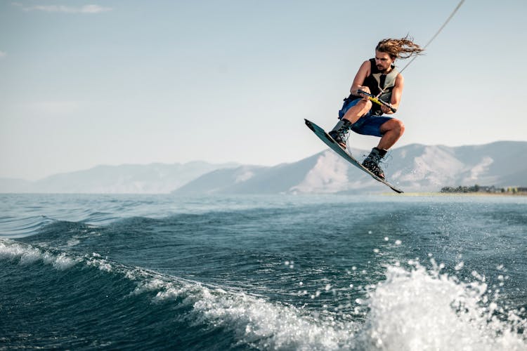 Man Wakeboarding On Sea Waves