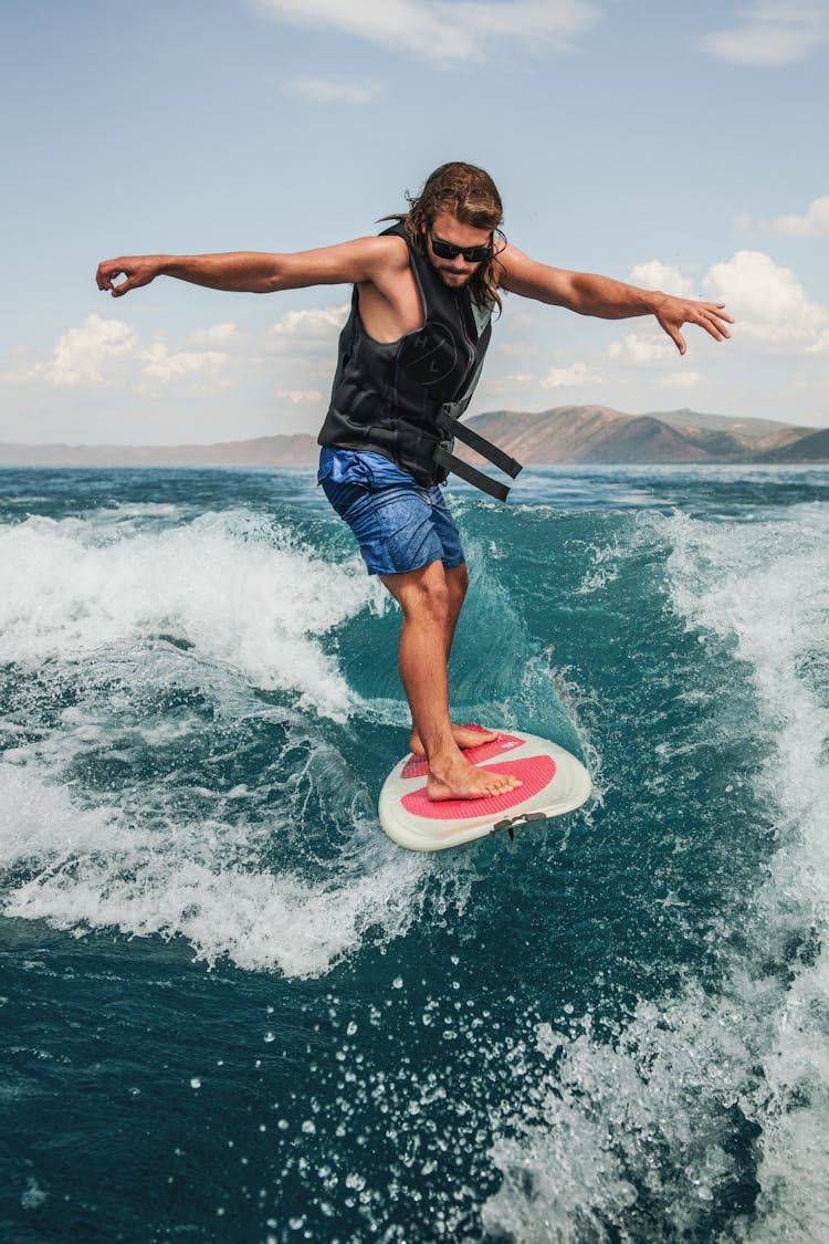 Man Surfing On Board In Ocean