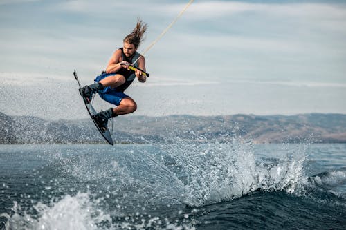 Free Man Wakeboarding in Ocean Stock Photo