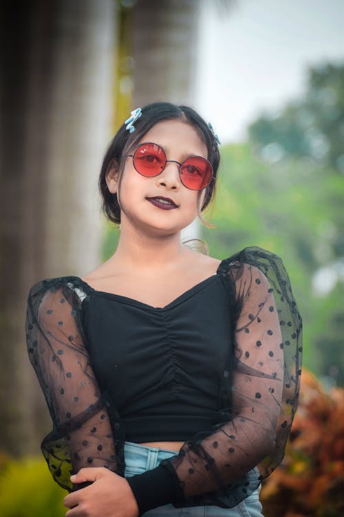 Young Brunette in Red Sunglasses 