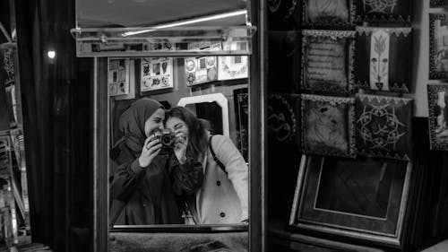 Women with a Camera Reflecting in a Mirror