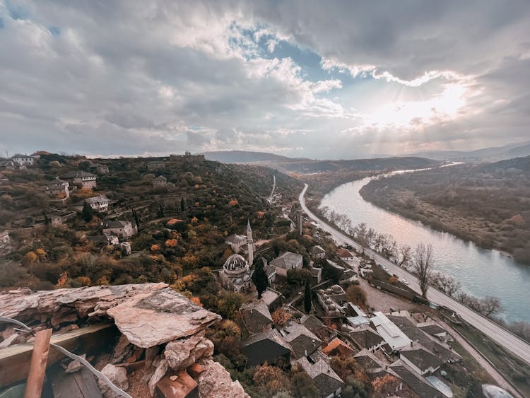 Landscape Of A Town On A Hill And A River