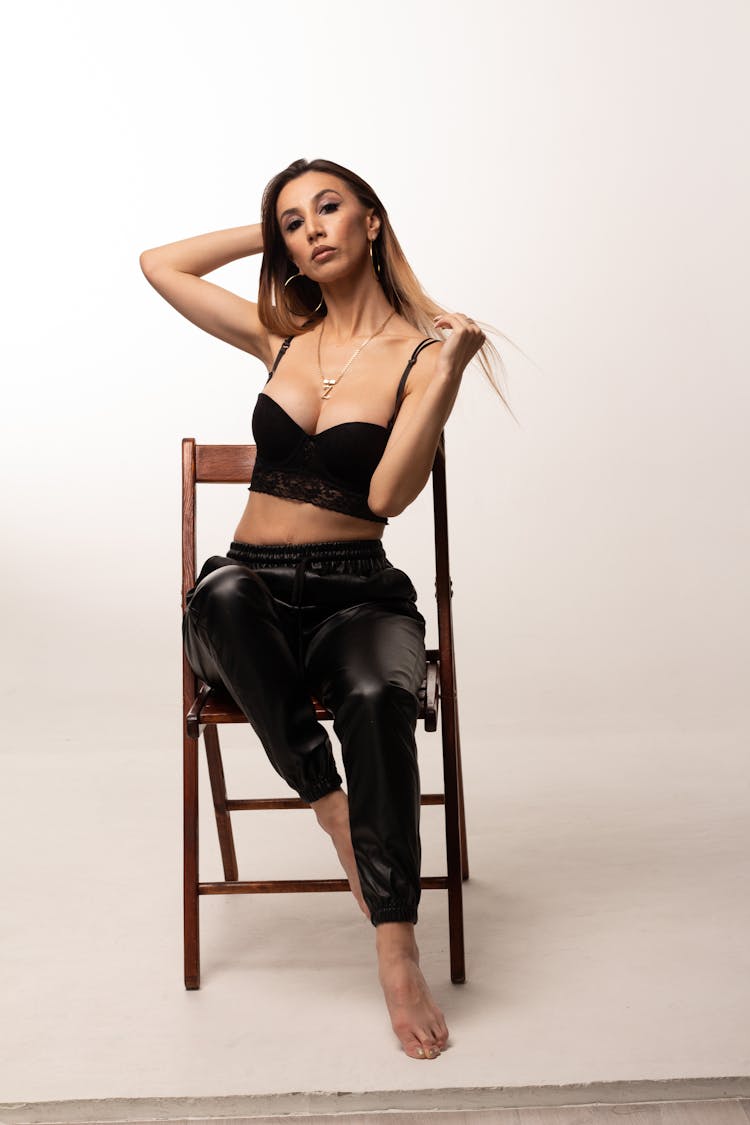 Woman In Black Bralette Sitting On A Chair