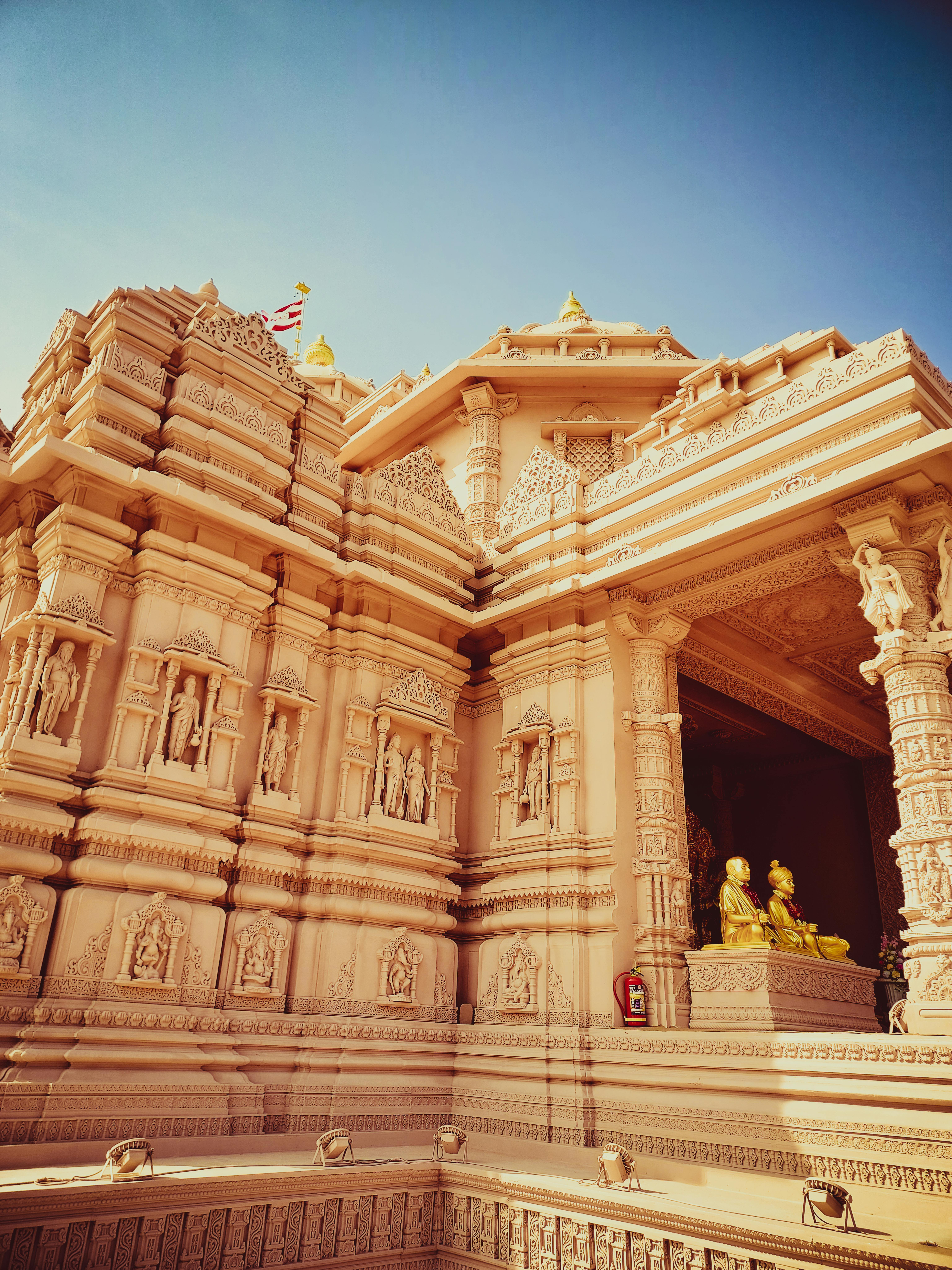 A temple with a large statue on top · Free Stock Photo