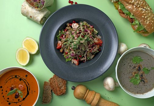 Colorful gourmet dishes including salads, soups, and sandwiches on a table, perfect for food lovers.