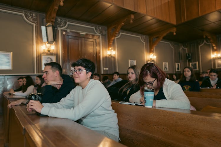 Men And Women Sitting In A Class