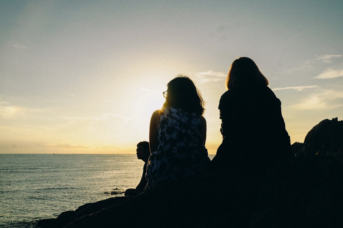 Free Silhouette of Two Women Facing Body of Water Stock Photo