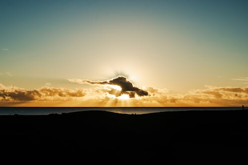 Free Silhouette of Beach Near Body of Water during Sunset Stock Photo