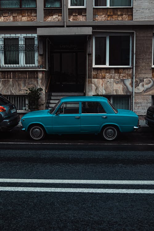 Photo of Blue Classic Car parked on Roadside