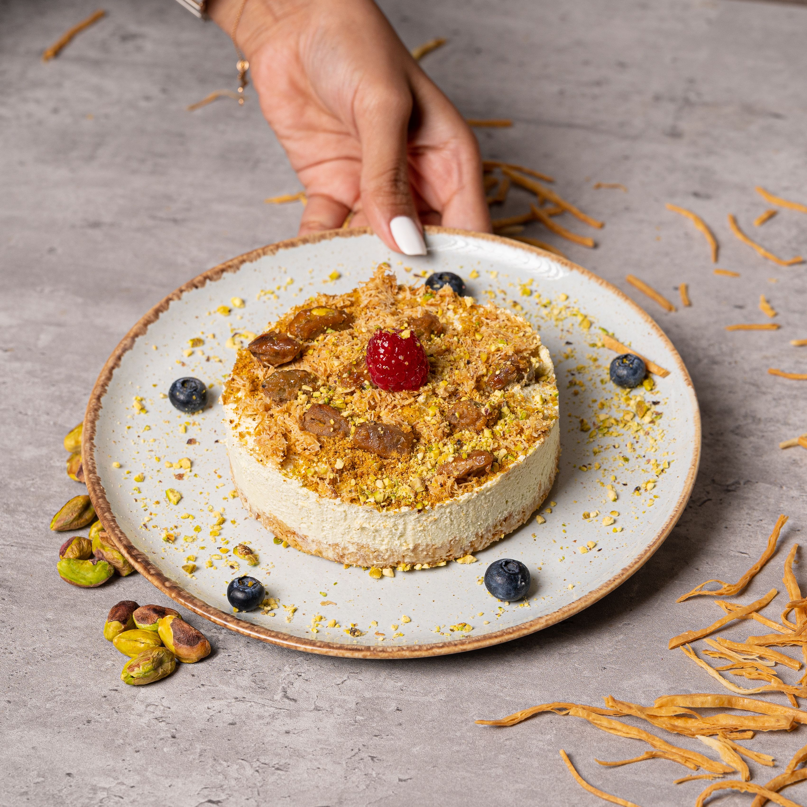 A person holding a plate with a dessert
