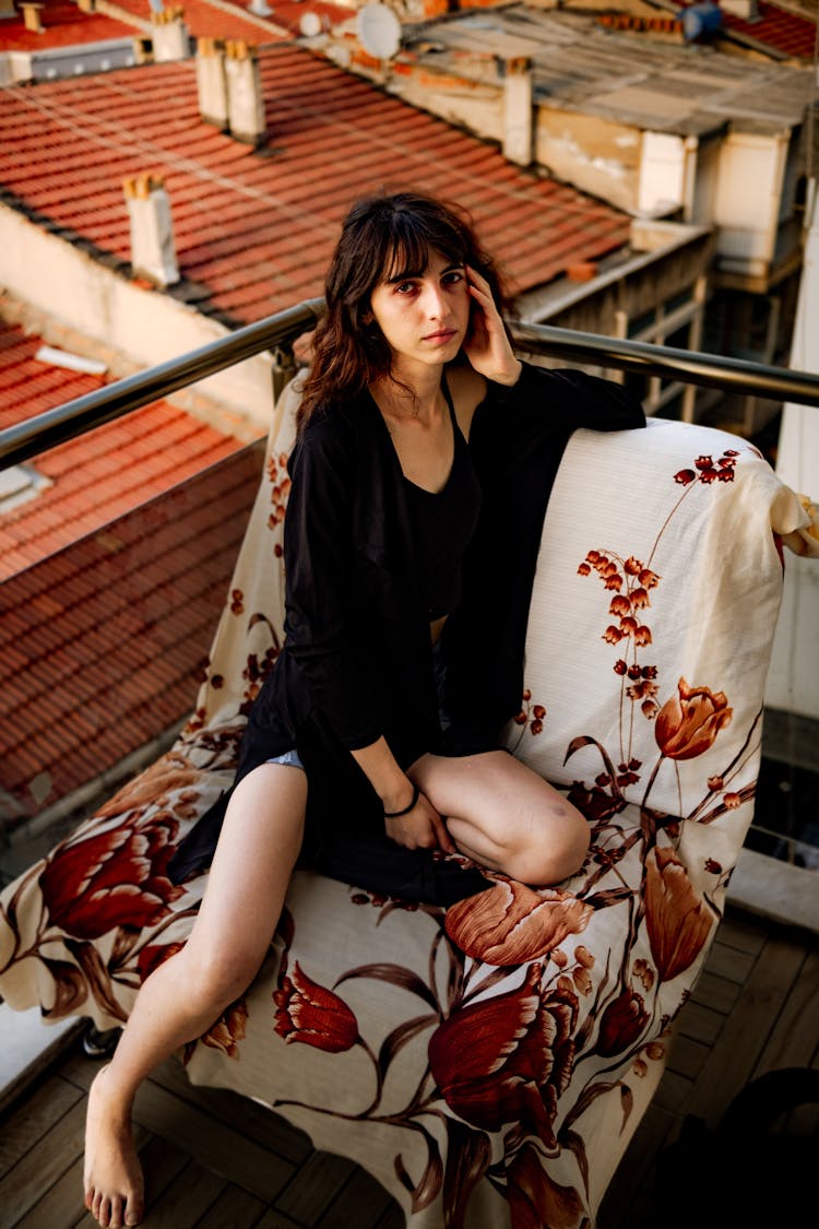 Woman Sitting On Balcony