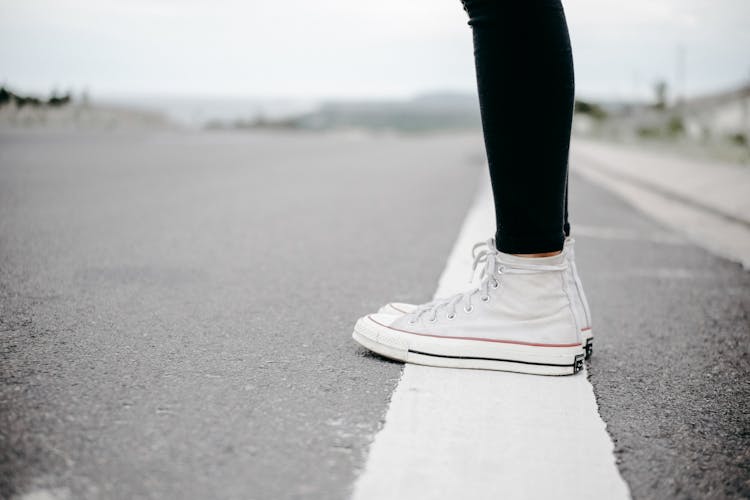 Person Wearing White High-top Lace-up Sneakers Standing On White Line