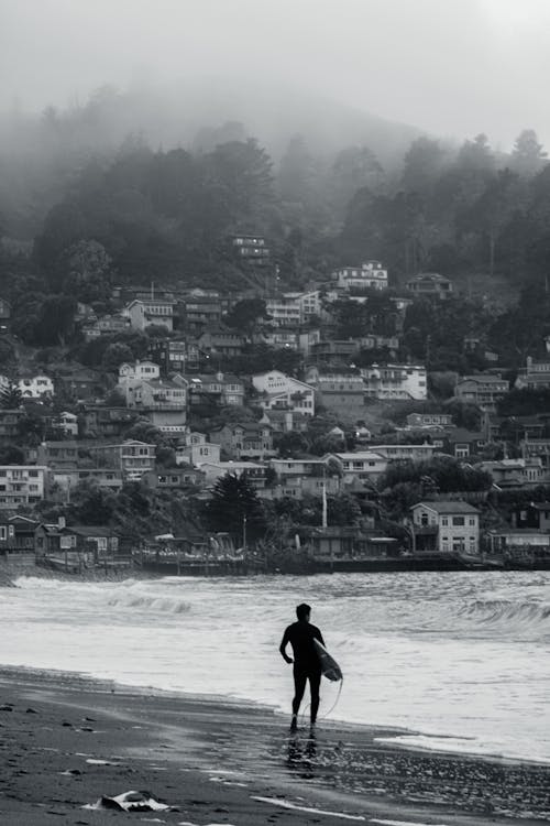 Man with a Surfboard on Linda Mar Beach, Pacifica, California, United States