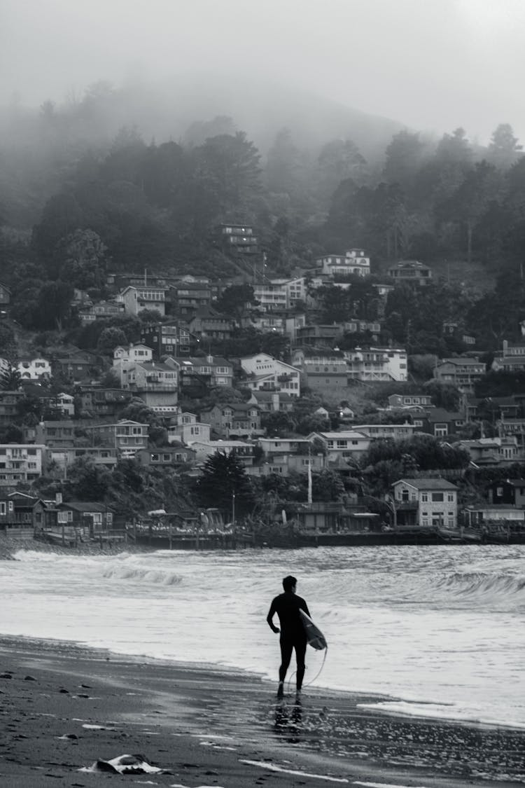 Man With A Surfboard On Linda Mar Beach, Pacifica, California, United States